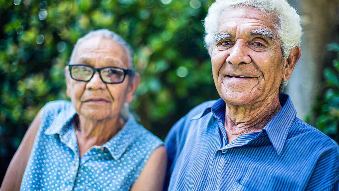 Portrait of a happy aboriginal senior couple relaxing in the backyard.